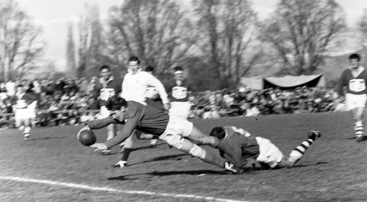 HEY DAY: Len Gaffey about to cross for a try for Kangaroos in the 1966 season, despite having an opponent around his ankles. 
