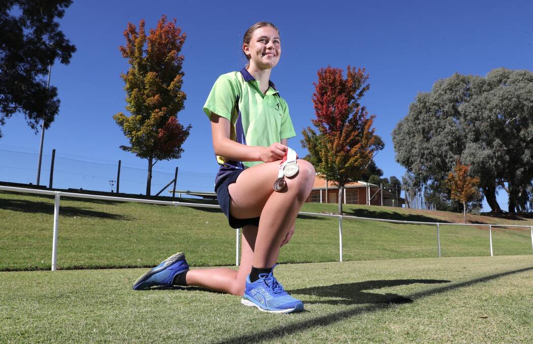 SUCCESS STORY: Hannah Mison with her gold medal from Little Athletics NSW State Championships, and bronze medal from the recent Australian Juniors athletics carnival. Picture: Les Smith