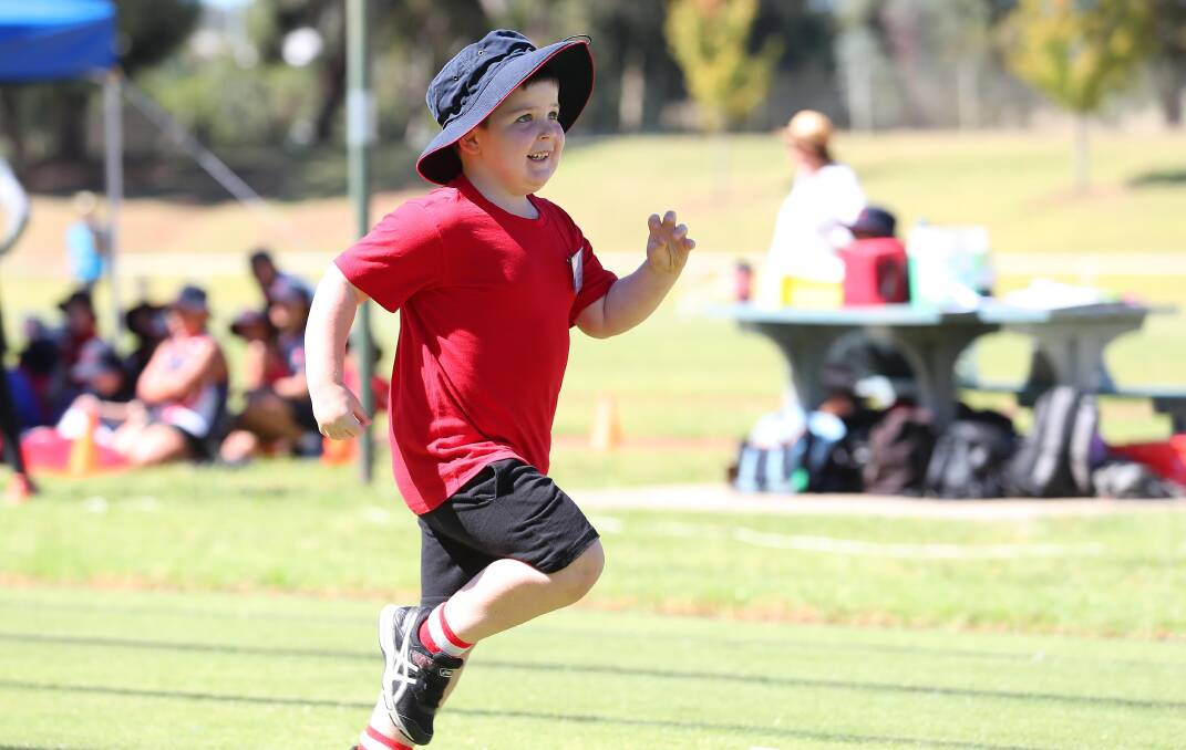 STRIDING OUT: Year One student, Jacob Gordon, is enjoying his sprint race at the Red Hill Public School athletics carnival at Jubilee Park.