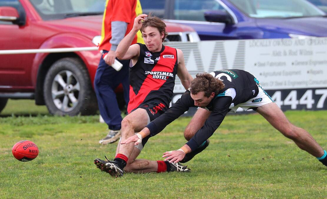 DESPERATION: Marrar's Rhys Mooney has Jets defender Mitch Doyle at full stretch as he soccers a shot towards goal at Langtry Oval.