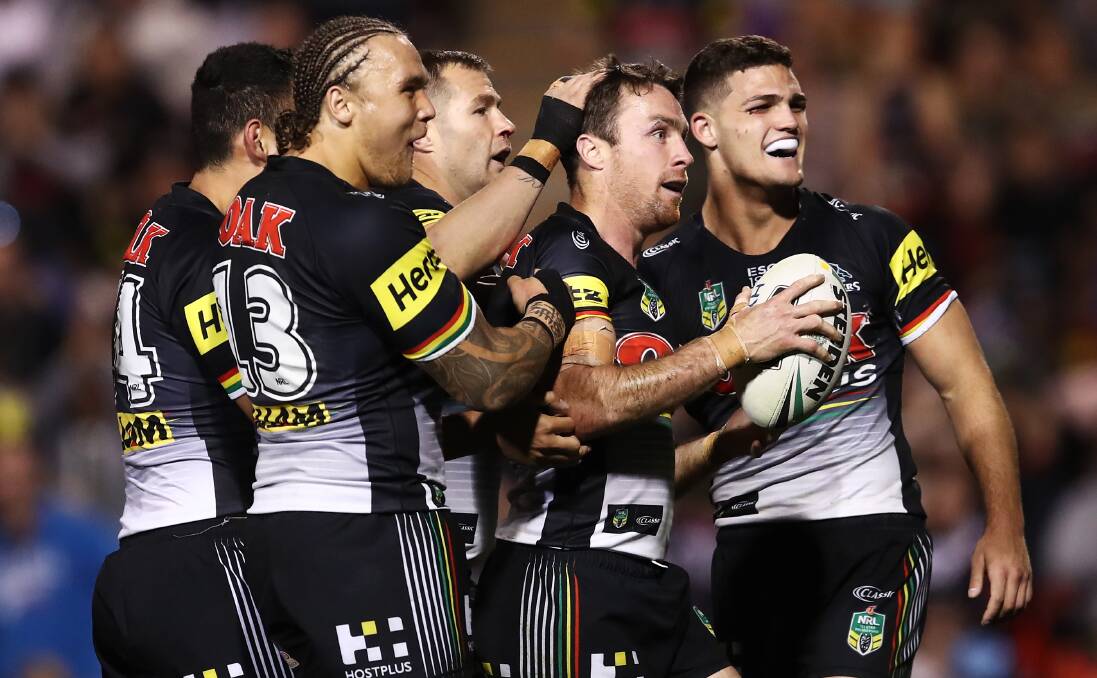 HEADLINE ACT: Panthers five-eighth James Maloney is congratulated by teammates, including star halfback Nathan Cleary (right) after a try against the Raiders. 