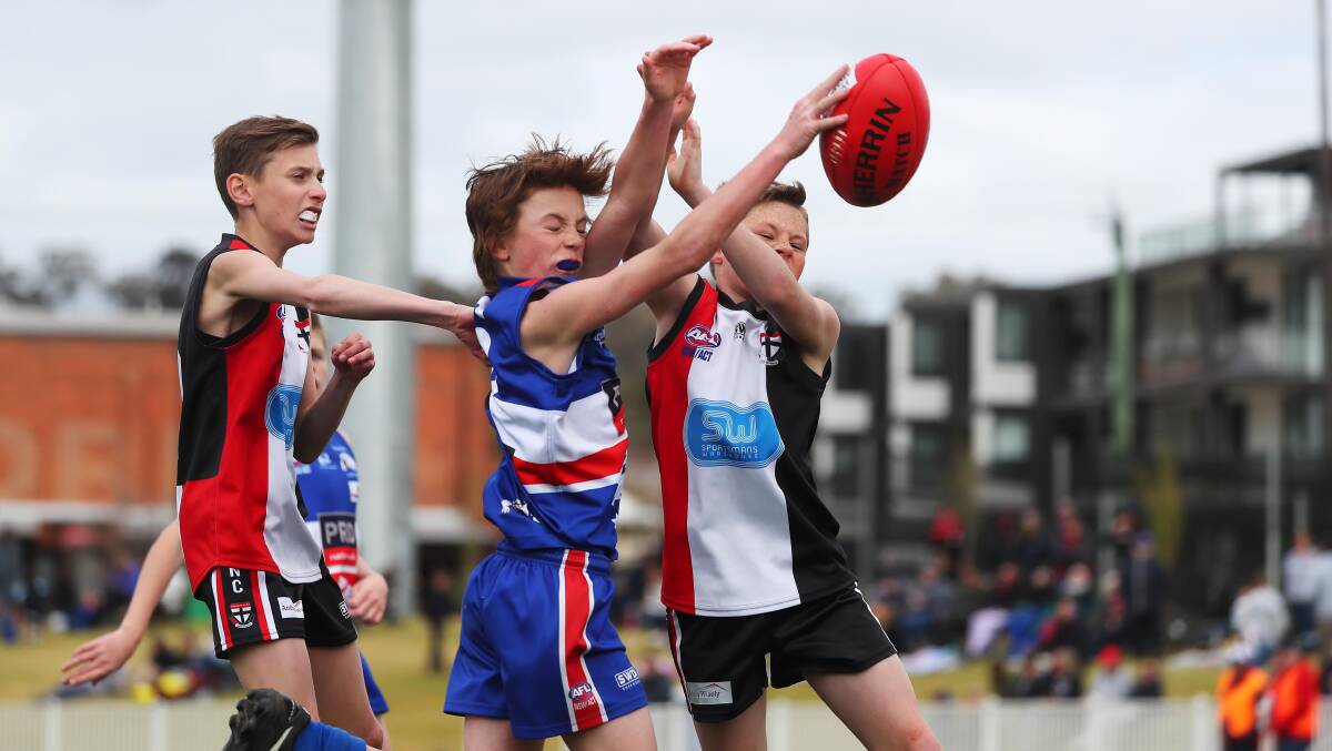 ROUGH AND TUMBLE: Turvey Park's Archie Jenkins is outnumber by North Wagga opponents on Wagga and District Juniors grand final day last year. Picture: Emma Hillier