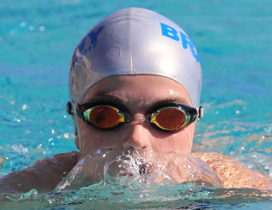 EYES UP: Jess Knox, 16, breaks the surface during her breaststroke event at Kildare Catholic College's swimming carnival on Thursday night. Picture: Les Smith