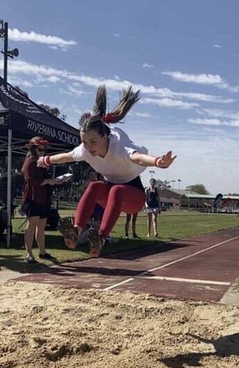 AIRBORNE: Year 12 student Sarah Deaner launches herself in the long jump at Wagga High School's athletics carnival. 