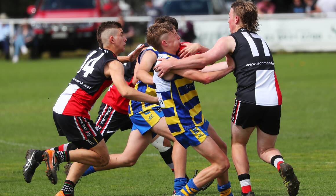 HEAVY TRAFFIC: Eastlakes-MCU's James Godde is brought to a halt by North Wagga in their under 15s semi-final last Sunday. Picture: Emma Hillier