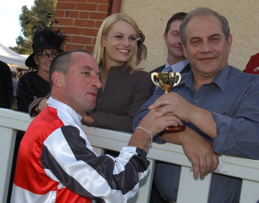 BIG WEEK: Jim Cassidy, with wife Vicki looking on, shares his 2003 Wagga Gold Cup win with mate John Mavroudis, Picture: Les Smith