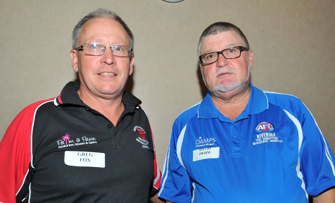 Departing Farrer League president David Oehm, right, with his successor Greg Fox. 