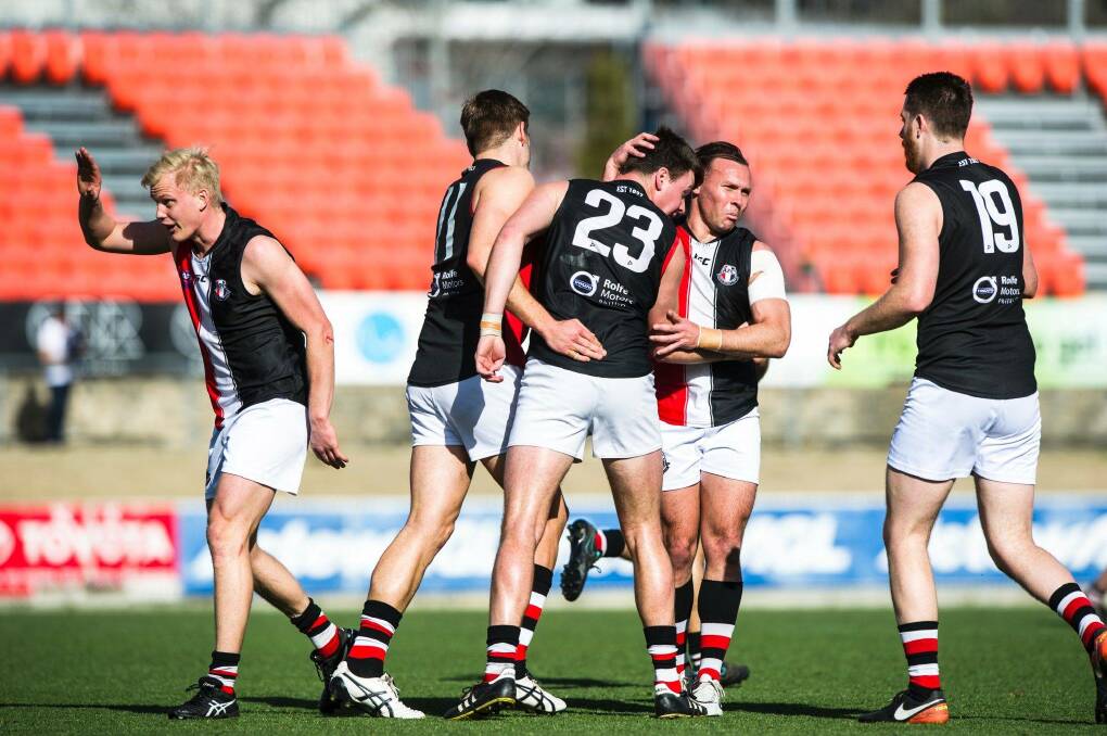Delves (23) celebrates with teammates during their second straight AFL Canberra premiership in 2017. 