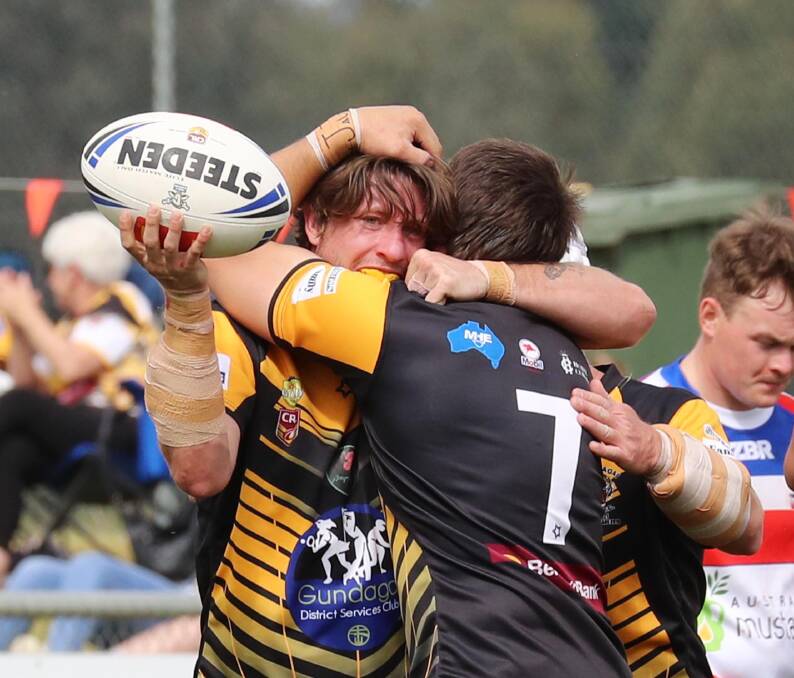 DOUBLE ACT: Gundagai fullback Kyle Ramage is embraced by man of the match, Chris Rose (7). Ramage scored three tries for the Tigers, two of which were off short balls from the halfback. Picture: Les Smith