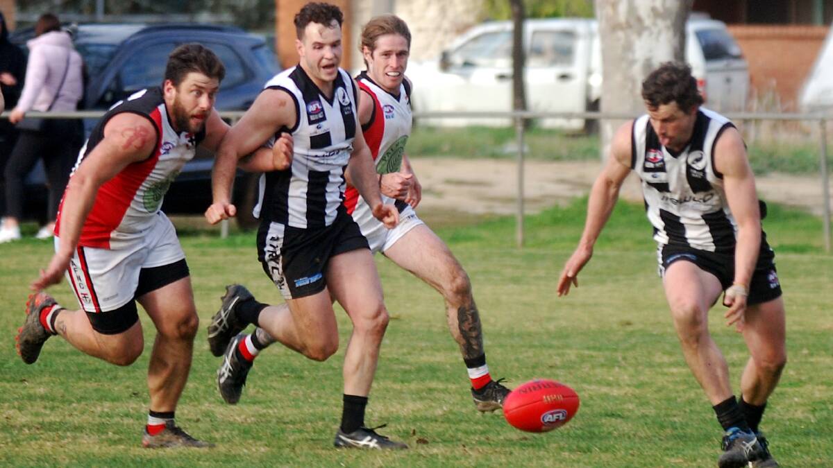 TRYC's Todd Hannam (right) scrambles to the footy in the final minute of their round 17 win against North Wagga... he got a handball off to Tom Collins who kicked the winner that put the 'Pies into third spot.