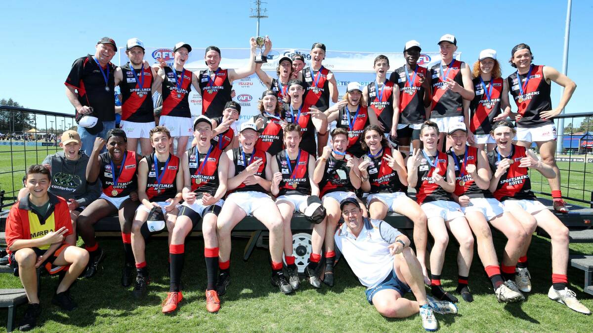 SHADOW CAST: The Bombers under 17.5 team celebrates its grand final win against East Wagga-Kooringal.