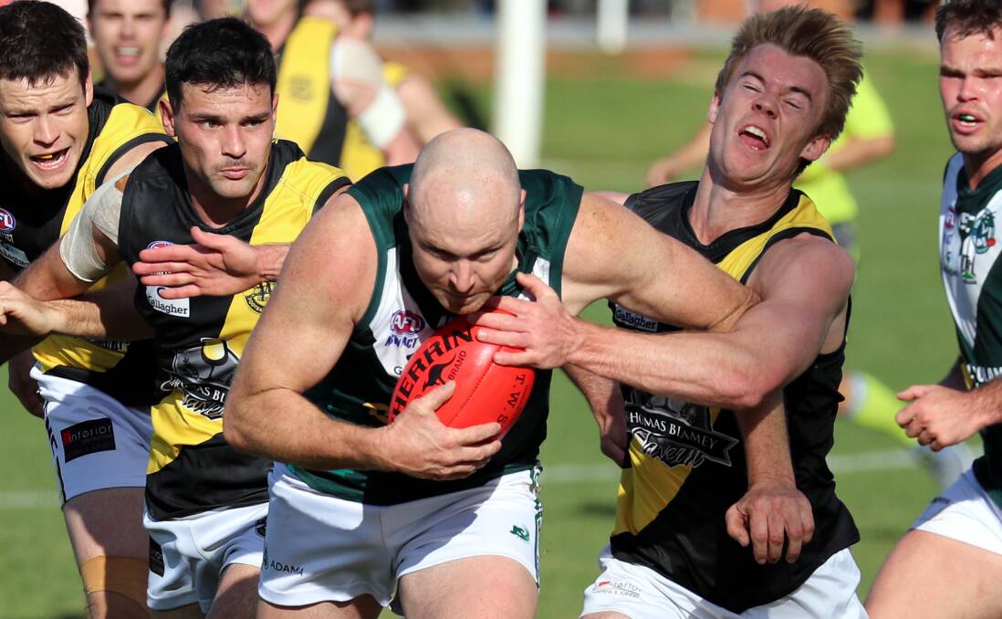 FULL STEAM: Coolamon co-coach Connor Neyland powers out of a Tigers' pack in the Hoppers' loss at home earlier this year. Picture: Les Smith