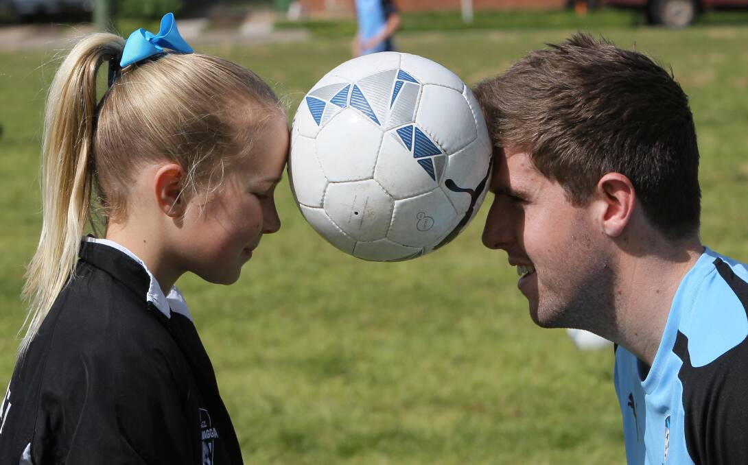 HEADS UP: Dedini with rising star Alethea Levy at a Sydney FC soccer clinic in 2016.