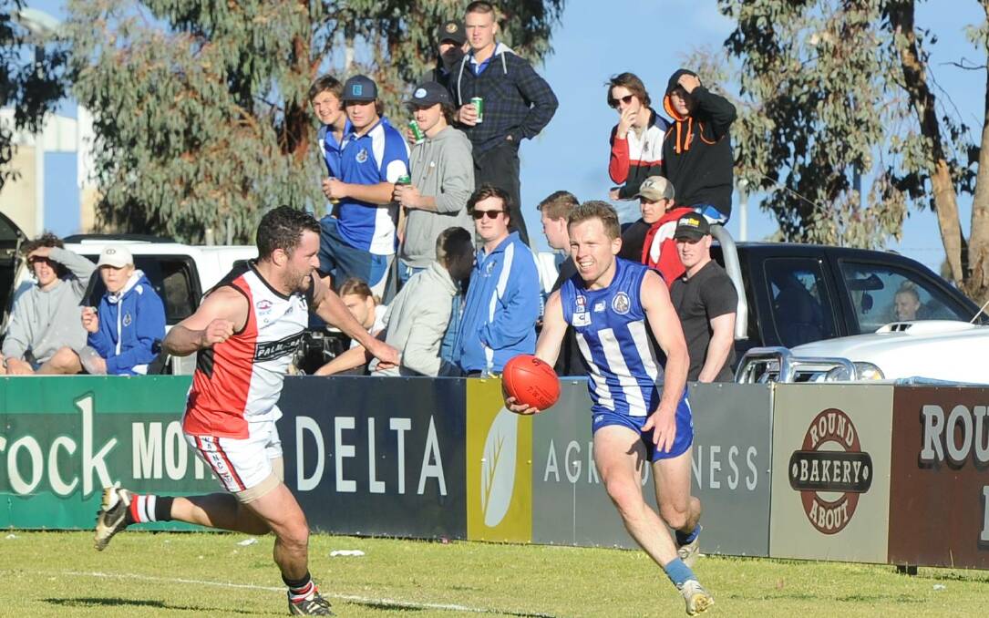 SMILING ASSASSIN: Dynamic Temora midfielder has the Nixon Park crowd on its feet as he takes on North Wagga's Jimmy Morris. Picture: Peter Doherty