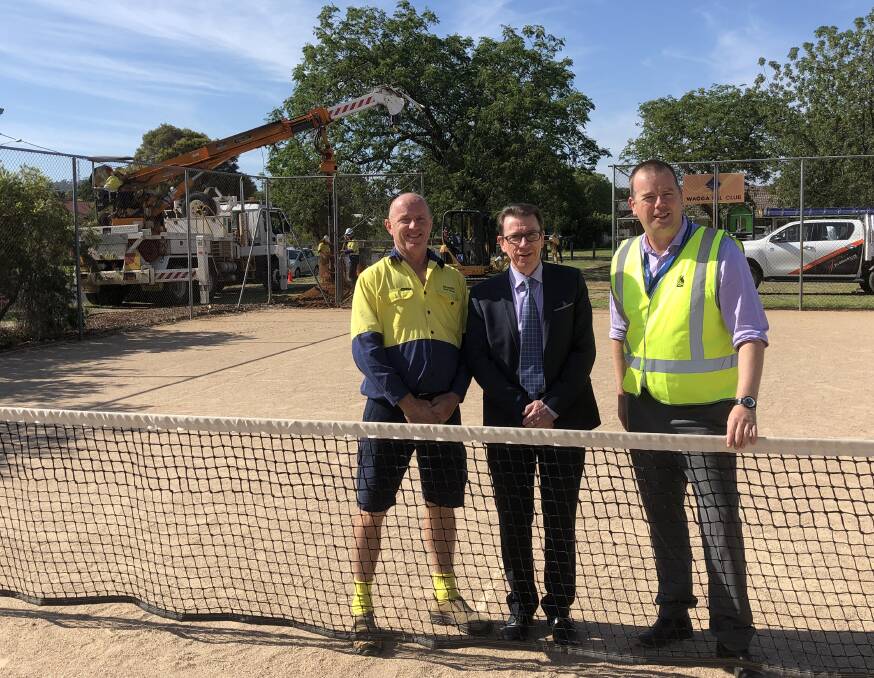 WORK UNDERWAY: South Wagga Tennis Club president Scott Toole (left) with Member for Wagga Dr Joe McGirr and Wagga City Council's Ben Creighton at the courts on Friday. Picture: Peter Doherty
