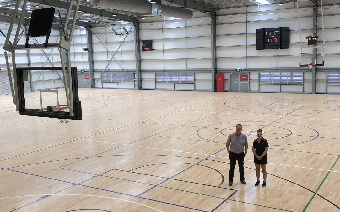 OPEN SPACE: Wagga Council's Ben Creighton and Fiona Claridge give a sense of scale to the new international standard stadium at Equex Centre during a visit this week. Picture: Peter Doherty
