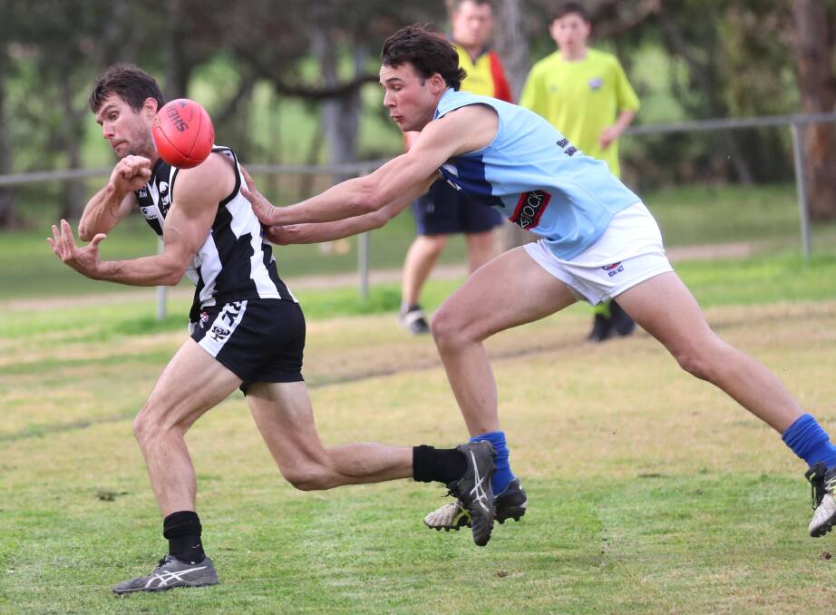 BIG DECISION: The Rock-Yerong Creek coach Tom Yates gets a handball away under pressure in Saturday's win against Barellan, his 150th game for the Magpies. Picture: Les Smith