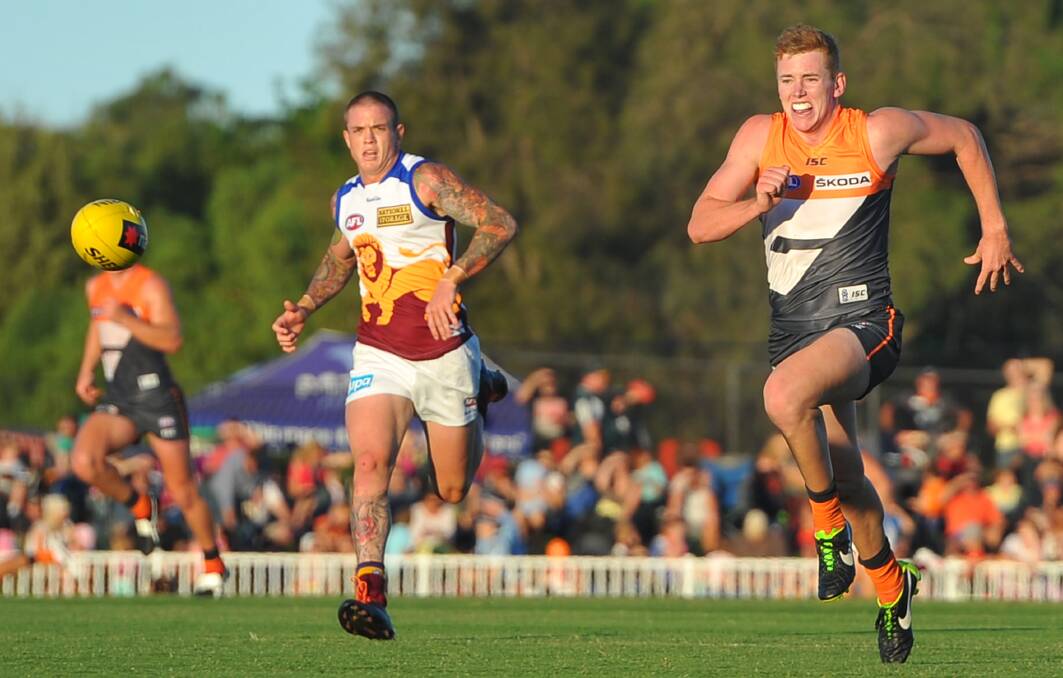 FULL FLIGHT: Jacob Townsend hopes to beat Brisbane's Claye Beams to the footy in a pre-season game for GWS at Wagga's Robertson Oval. Picture: The Daily Advertiser