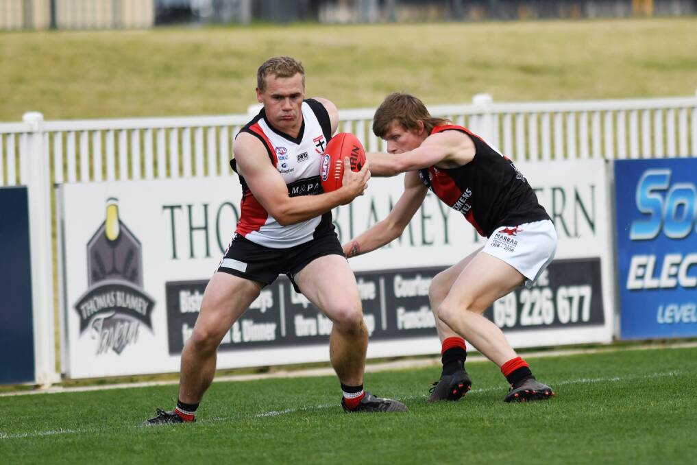 ON A MISSION: North Wagga coach Kirk Hamblin tries to get around Marrar's Rory Block in the Saints' preliminary final victory at Robertson Oval on Saturday. 