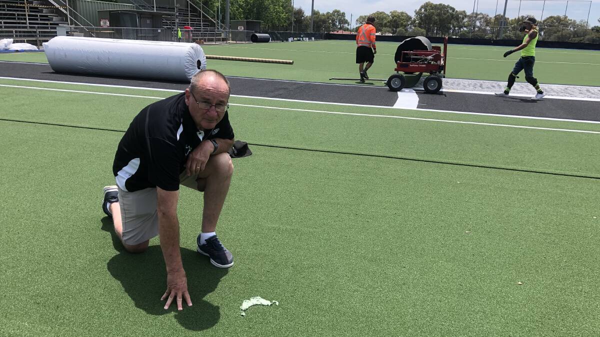 DAMAGE DONE: Wagga Hockey president Ken Larkin at Jubilee Park inspecting the glue damage to the new surface which is being laid. Picture: Peter Doherty