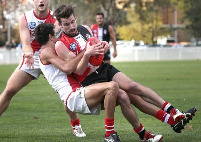Logan Gray tackles Ainslie's Chris Barrie in a NEAFL game for Eastlake in 2015. Picture: Jeffrey Chan, The Canberra Times