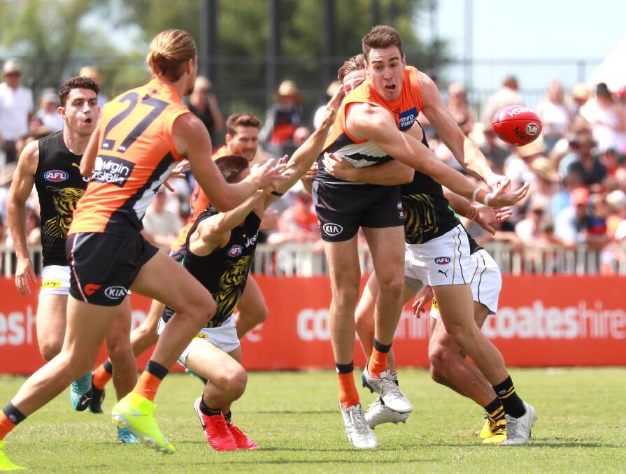 HERE YOU GO HARRY: Giants forward Jeremy Cameron
hands off to Harry Himmelberg in their win against
Richmond at Robertson Oval. Picture: Les Smith