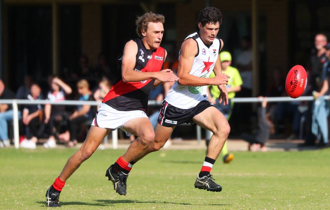BATTLE ROYALE: Marrar's Jack Reynolds and North Wagga's Elliott Winter compete during Saints' victory at McPherson Oval last year. 
