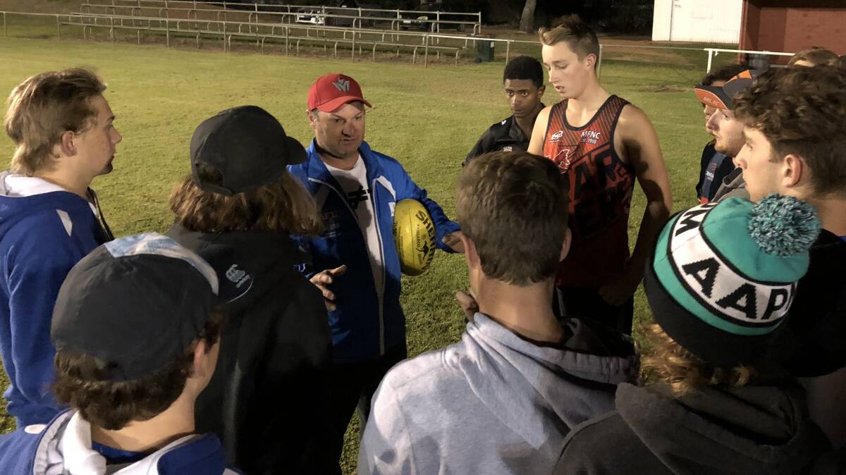 TAKE THE GAME ON: Farrer League under 17.5 representative coach Nigel Smith addresses his players at their final training session at Maher Oval on Thursday night.