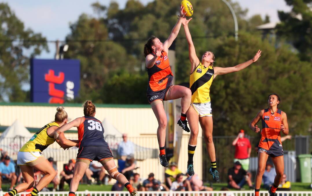 GAME ON: Opposing rucks Jessica Allan (GWS) and Alice Edmonds (R) fly at Robertson Oval in GWS Giants' big win against Richmond in the AFLW game on Saturday. Picture: Emma Hillier