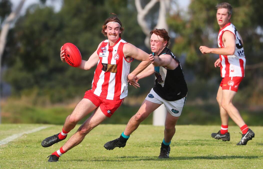 FUN AND GAMES: CSU's Connor Kelly tries to get clear of Northern Jet Hamish Gaynor in Saturday's game at Peter Hastie Oval. Picture: Emma Hillier