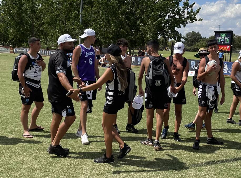 EMOTIONAL: Wests Under 16 boys coach Milad Almaou is congratulated after leading the team to an unexpected grand final win. Picture: Peter Doherty