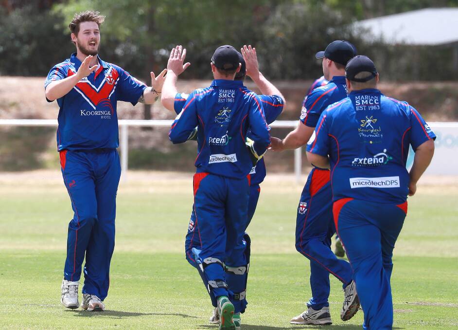 Celebrating a wicket with teammates in 2019. Picture: Les Smith