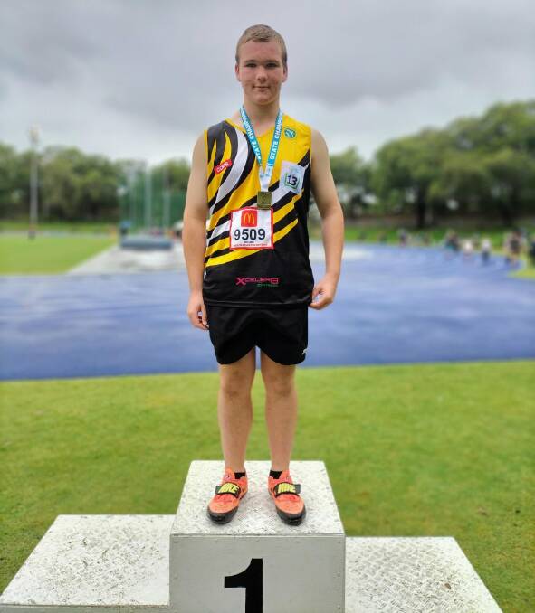 STATE'S NUMBER ONE: Cooper Dabin on top of the dais after winning the under 13 boys discus at NSW Little Athletics Championships.