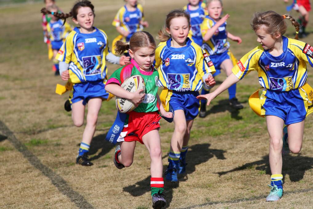 DETERMINED: Brothers' Bridget Fitzgibbon powers towards the tryline with the Junee defenders in hot pursuit in their Under 8s leaguetag game on Saturday. Picture: Emma Hillier