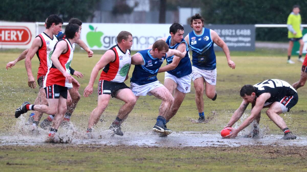 WET WINTER: North Wagga and Barellan do battle in the McPherson Oval mud last year.
