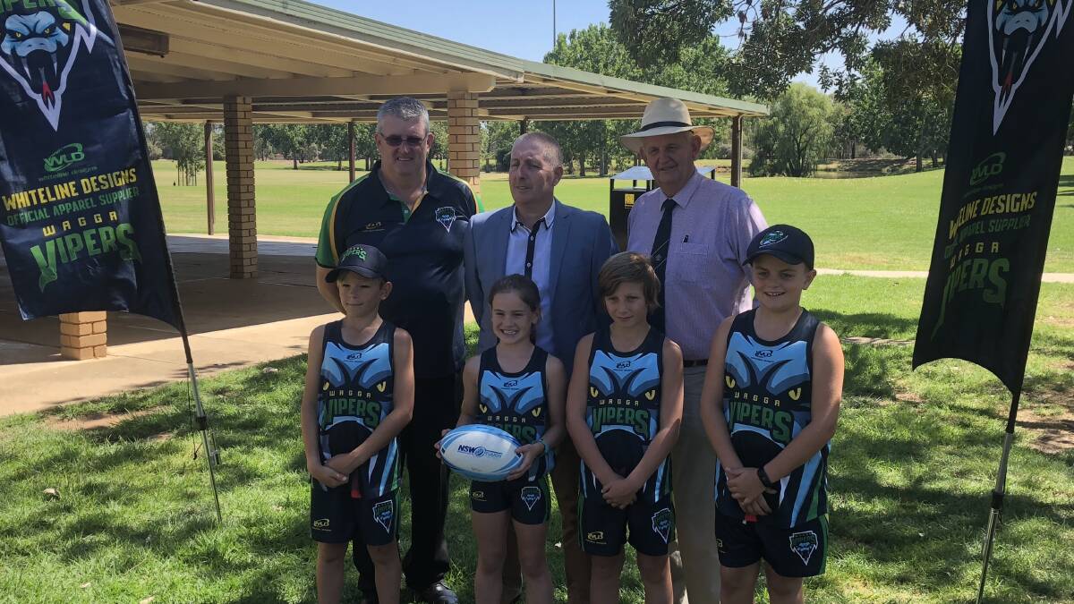 BIG NEWS: (back, from left) WTA president Chris Dolahenty, NSW Touch general manager Dean Russell and Mayor of Wagga, Greg Conkey, joined by junior Wagga touch players at Tuesday's announcement. 