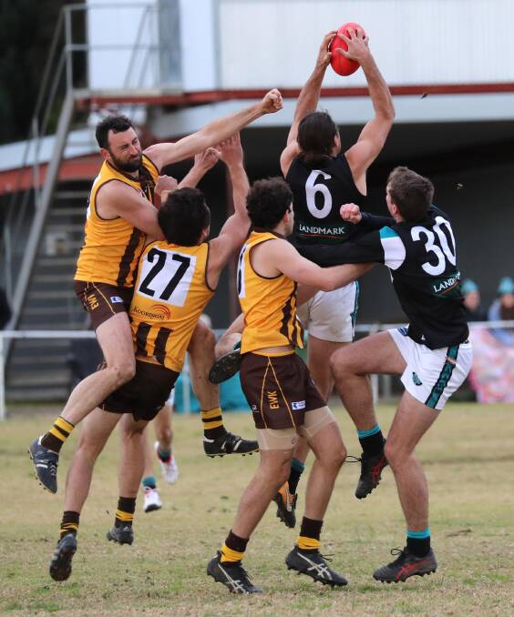 STRONG: Northern Jets' Mitch Haddrill takes a mark in front of a pack including Hawk Brenton Roberts (left) at Gumly Oval on Saturday. Picture: Les Smith