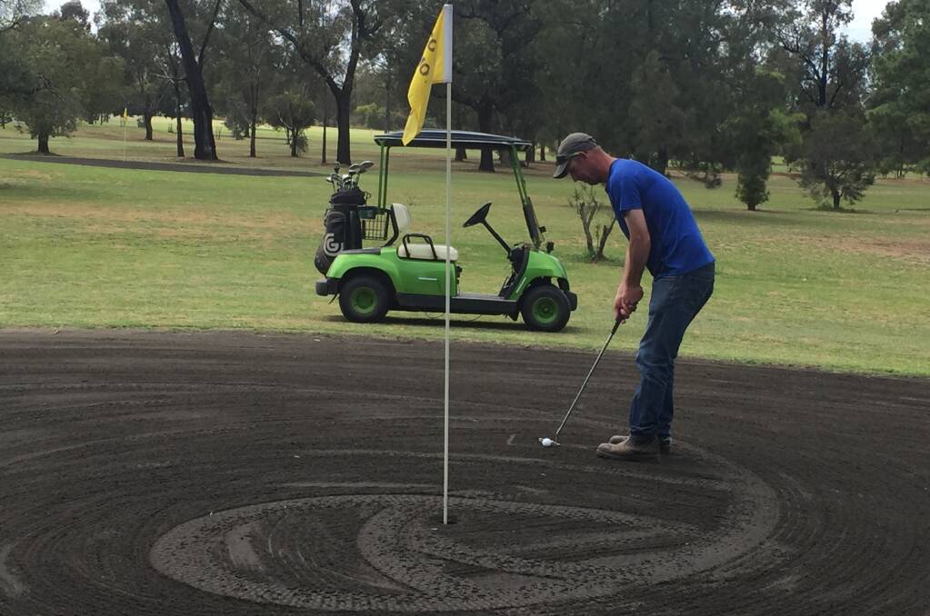HOSTING HONOURS: Coolamon club captain Grubby Broadhead tests out the greens ahead of the state's best arriving for the NSW Sand Green Championships this weekend. Picture: Mick O'Brien