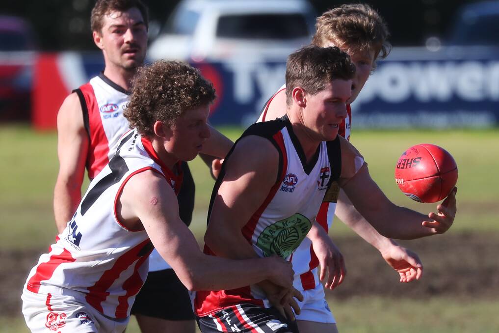PIG PRESSURE: CSU's Harry Turner keeps the heat on North Wagga forward Josh Thompson in Saturday's game at McPherson Oval. Picture: Emma Hillier