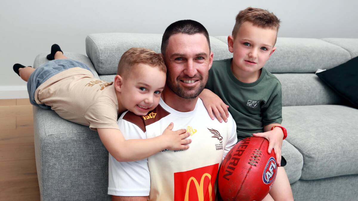 FAMILY CALLING: Ben Absolum at home with sons Beau, 4, and Mason, 6, this week. The Hawks midfielder and premiership-winning captain says it's time to wrap up a memorable career. Picture: Les Smith