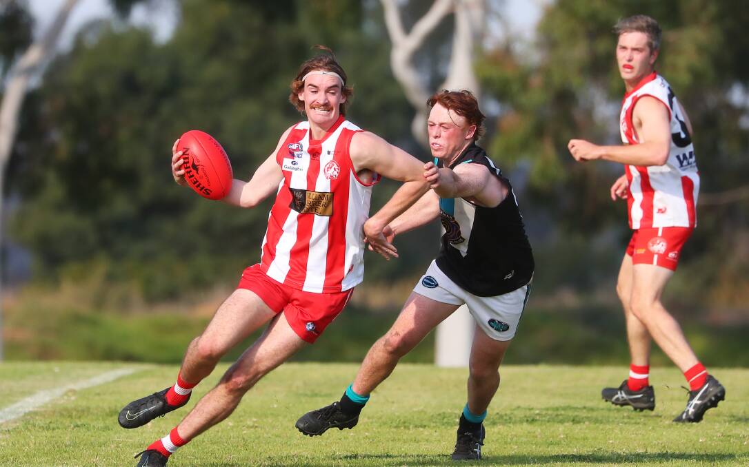'PIGS V JETS: CSU's Connor Kelly tries to get around Northern Jets young gun Hamish Gaynor last season.