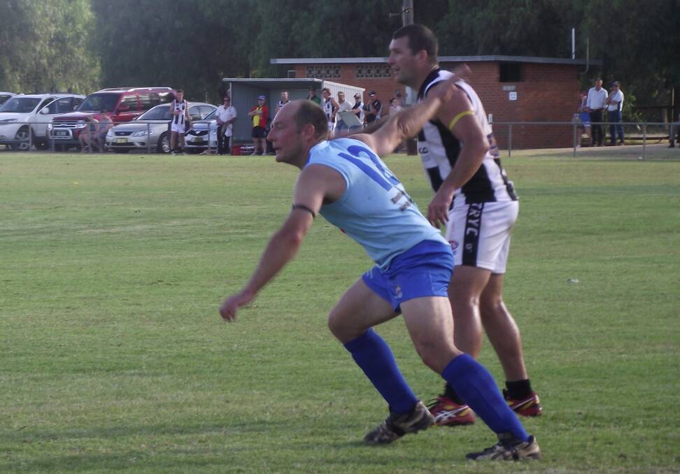 Jeff Mickan marks TRYC's Andy Carey in Barellan's first game back in the Farrer League in 2015. 
