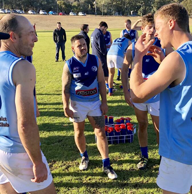 Gun midfielder Sean Ellis in the centre as Jeff Mickan (left) and Matt Irvin (right) discuss their efforts at three-quarter-time against CSU earlier this year. Picture: Peter Doherty