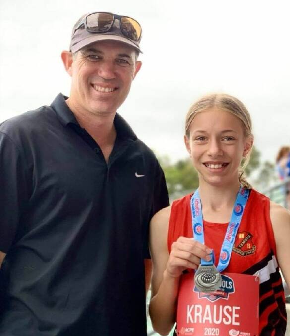 STATE CHAMPION: Temora's Grace Krause with coach Greg Wiencke after her medal haul at NSW All Schools. 