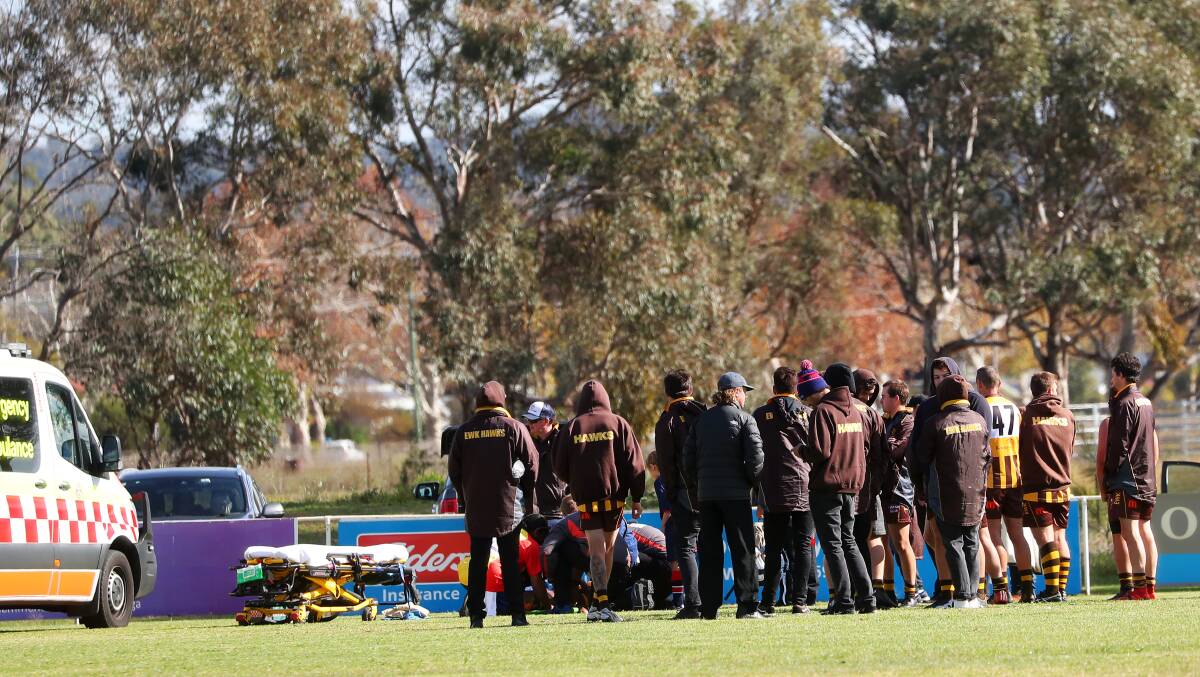 CONCERN: Paramedics attend to East Wagga-Kooringal's Chris Thwaites after he injured his neck at Gumly on Saturday. 
