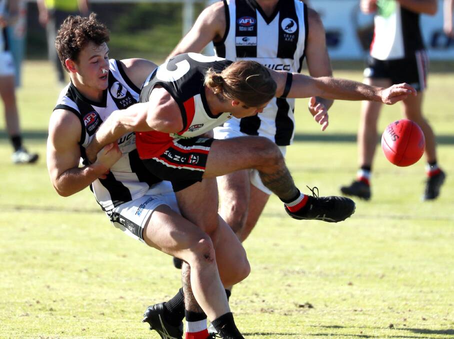 PRESSURE GAME: The Rock-Yerong Creek midfielder Joe Hancock wrestles North Wagga's Corey Watt away from the footy but Watt had the last laugh with a fine game in the Saints' win. Picture: Les Smith