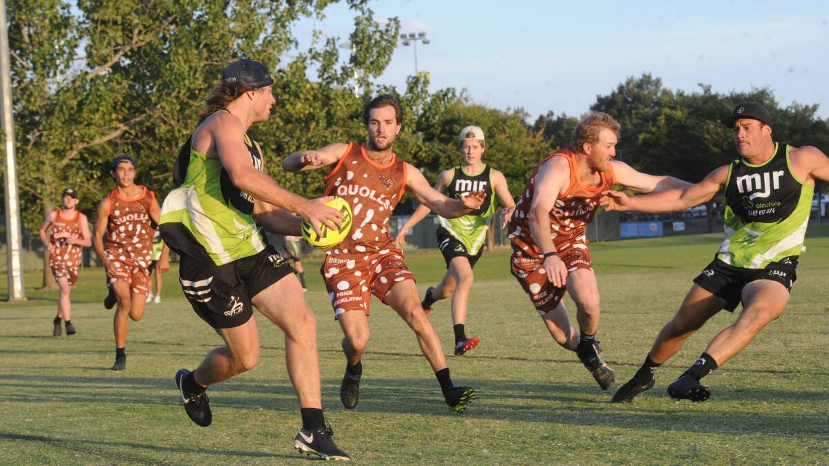KEY ROLE: The returning Campbell Lovell (left) sets up another attacking raid for MJR Electrics despite the attention of Quolls coach Cade Price in Tuesday night's men's Premier League preliminary final. 