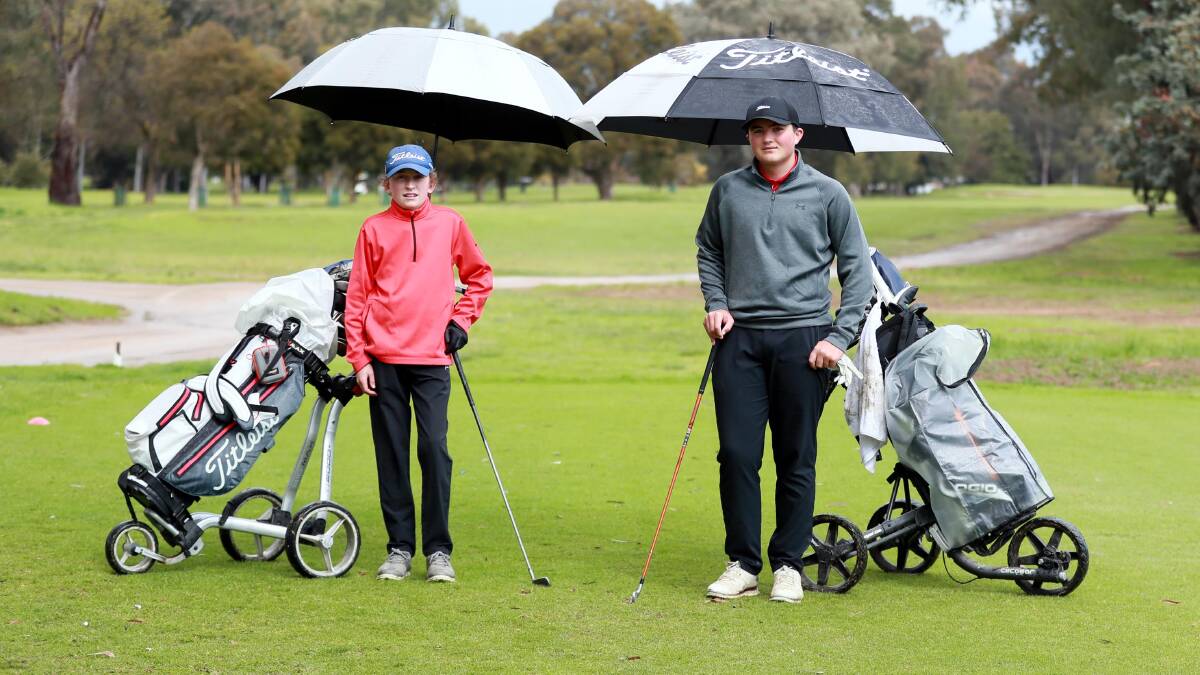 KEEN: William O'Connell (left), 14, and Will Johnson, 16, braving the conditions for a hit during lockdown on a wet Sunday morning at the end of August. Picture: Les Smith