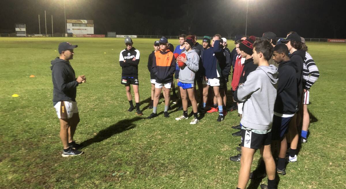Farrer Under 17s coach Craig De Piazza addresses his players before training on Thursday night.