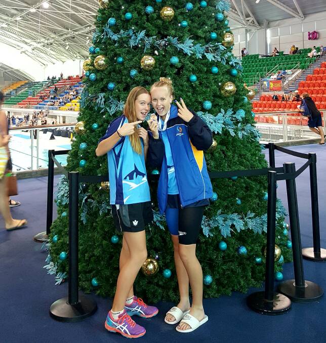 REASON TO CHEER: Abbey and Meg Senior at the NSW state age swimming championships just before Christmas. The sisters have a big 2019 ahead including nationals in April. 